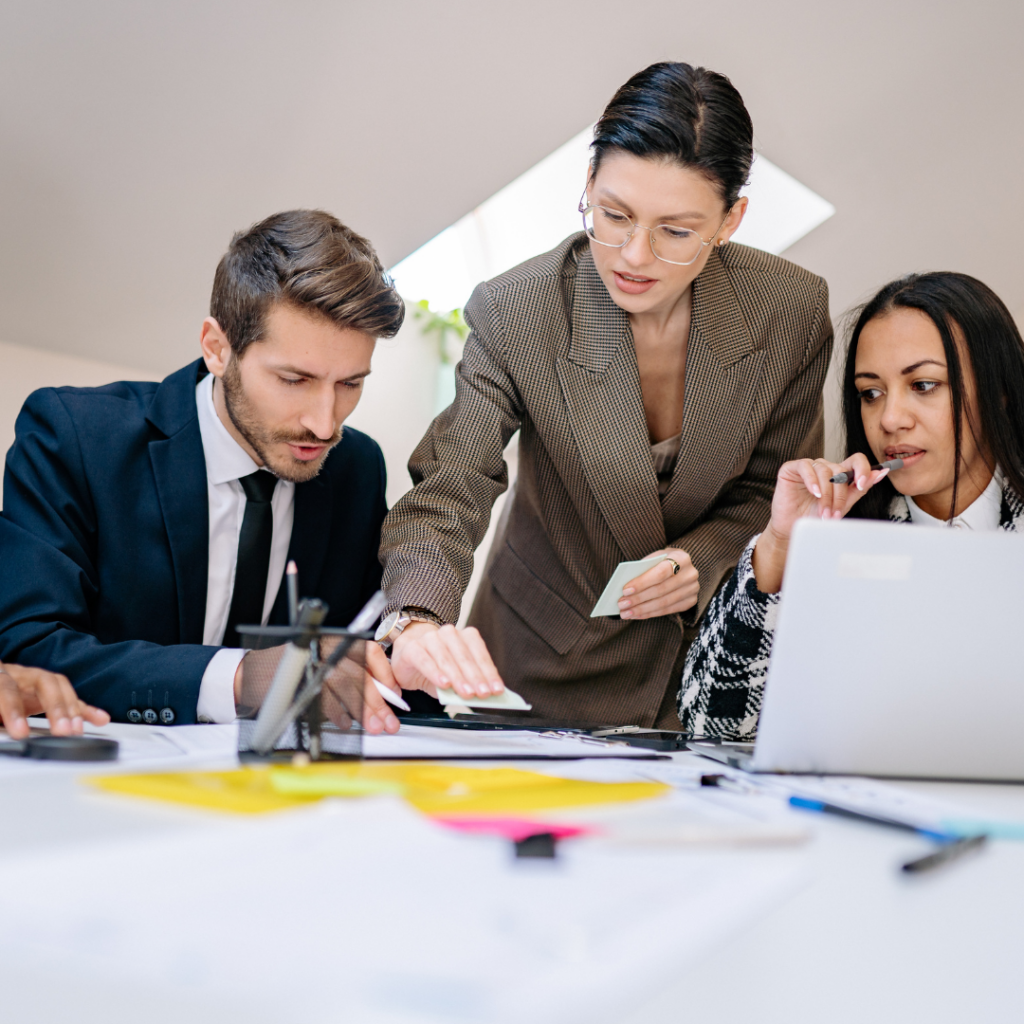 image of people busy working on a desk